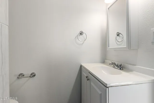 a bathroom with a sink and vanity