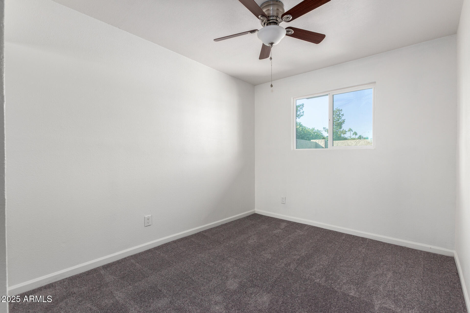 830 South Dobson Road, Unit 98 Mesa, AZ 85202 - Photo 21 of 25 an empty room with a ceiling fan and window