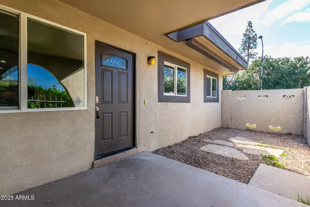 a view of a house with a door and wooden walls