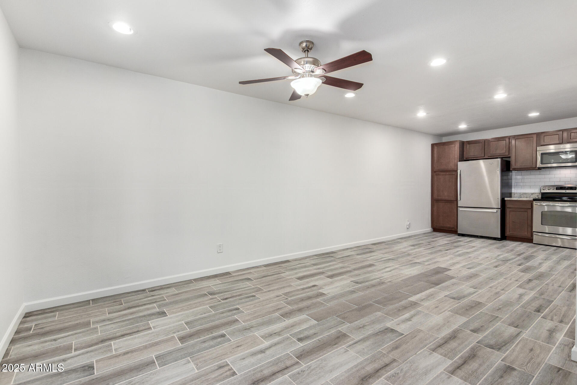 830 South Dobson Road, Unit 98 Mesa, AZ 85202 - Photo 6 of 25 a view of a livingroom with a ceiling fan and wooden floor