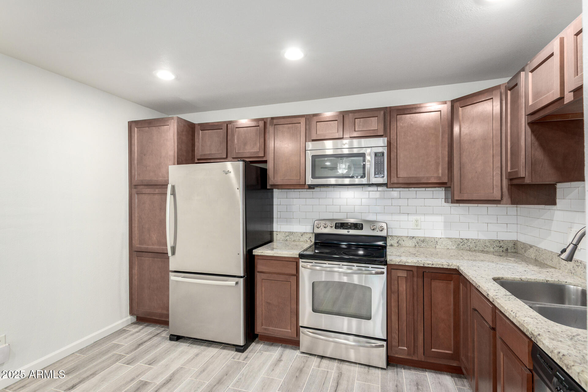 830 South Dobson Road, Unit 98 Mesa, AZ 85202 - Photo 7 of 25 a kitchen with stainless steel appliances a refrigerator stove and sink
