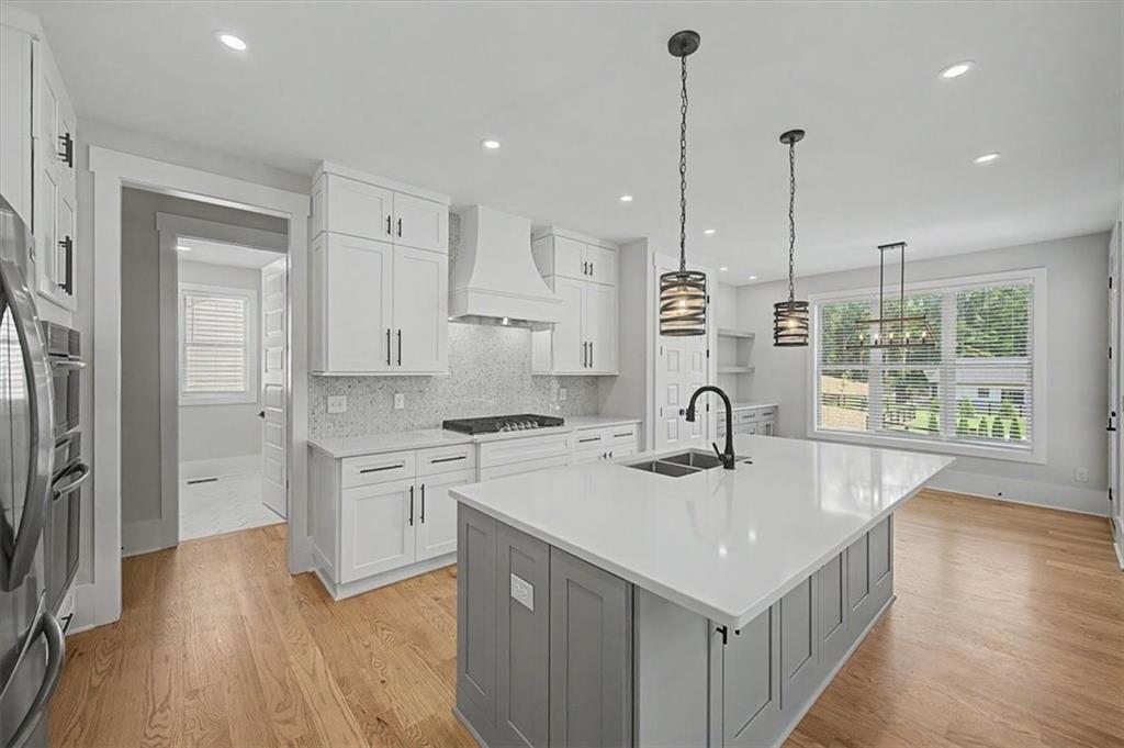 217 Laura Lake Road Marietta, GA 30066 - Photo 16 of 54 a kitchen with stainless steel appliances granite countertop a sink stove and wooden floor