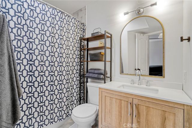 a bedroom with a bed and large window