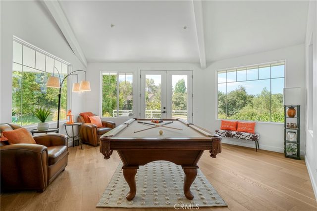 a living room with table a table and a large window