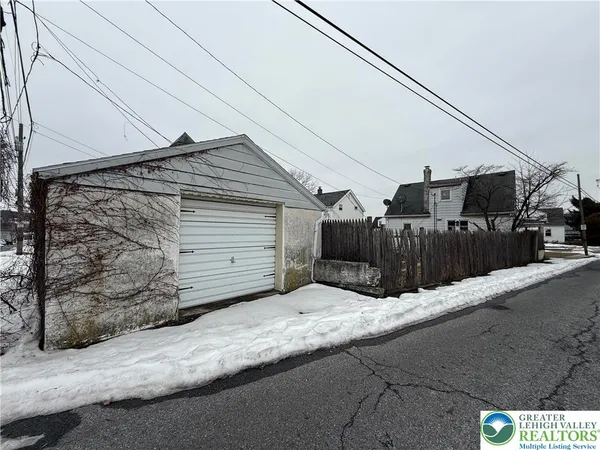 a view of a house with a wooden fence