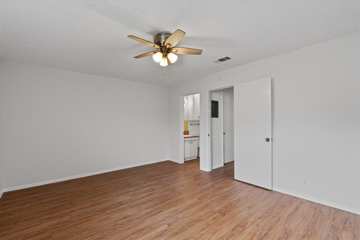 3426 Willowrun Drive, Unit B Austin, TX 78704 - Photo 12 of 16 a view of empty room with wooden floor and fan