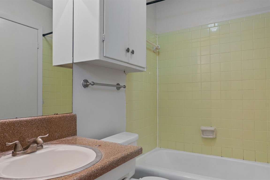 3426 Willowrun Drive, Unit B Austin, TX 78704 - Photo 14 of 16 a bathroom with a granite countertop sink and a mirror