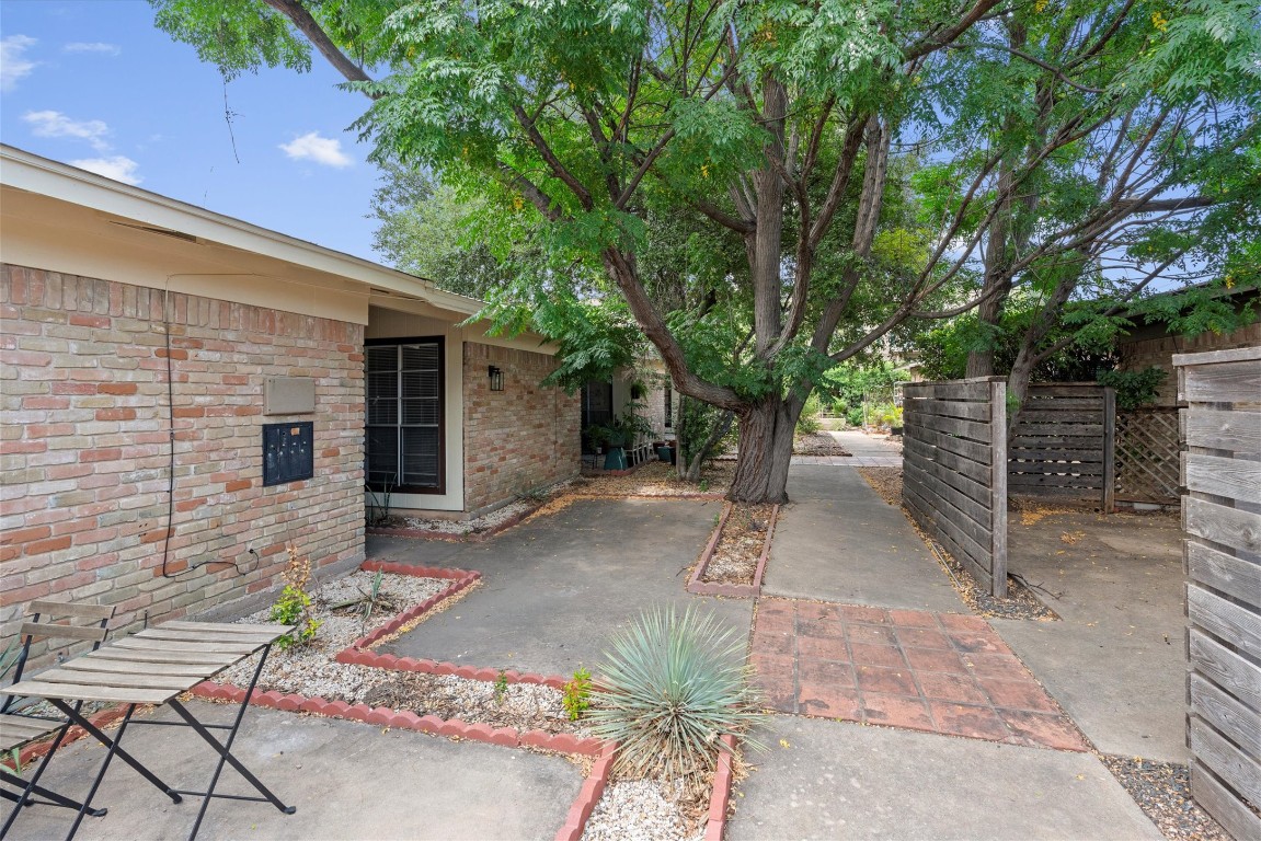 3426 Willowrun Drive, Unit B Austin, TX 78704 - Photo 2 of 16 a view of a patio with table and chairs and a large tree
