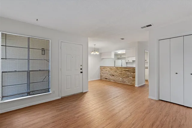 a view of a big room with wooden floor and cabinet