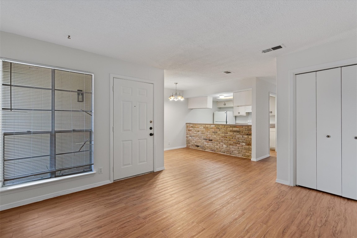 3426 Willowrun Drive, Unit B Austin, TX 78704 - Photo 4 of 16 a view of a big room with wooden floor and cabinet