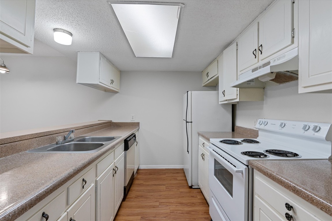 3426 Willowrun Drive, Unit B Austin, TX 78704 - Photo 7 of 16 a kitchen with stainless steel appliances granite countertop a sink a stove and a refrigerator