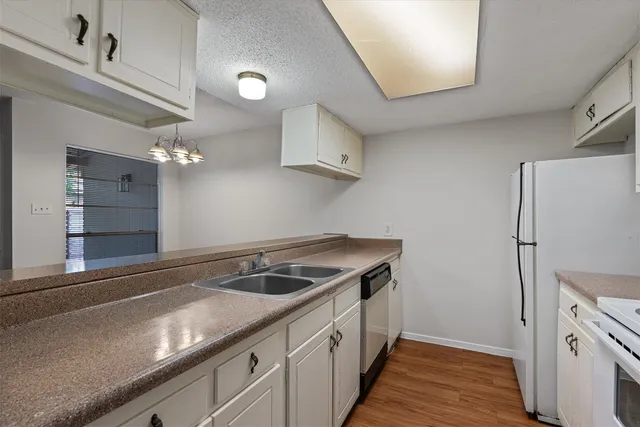 a kitchen with a sink and a refrigerator