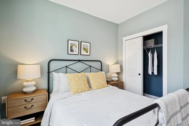 a bedroom with a bed and a night stand