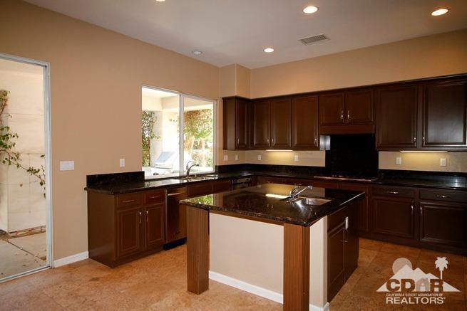 324 Loch Lomond Road Rancho Mirage, CA 92270 - Photo 13 of 51 a kitchen with granite countertop wooden cabinets and a granite counter top