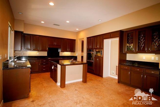 324 Loch Lomond Road Rancho Mirage, CA 92270 - Photo 15 of 51 a kitchen with stainless steel appliances granite countertop a stove refrigerator sink and cabinets