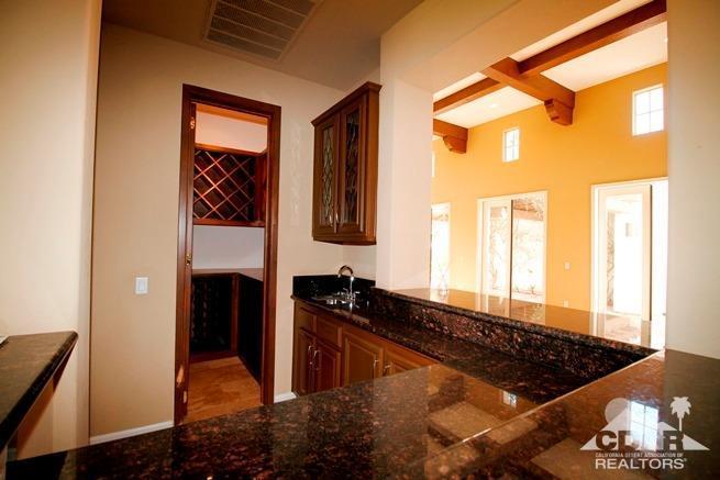 324 Loch Lomond Road Rancho Mirage, CA 92270 - Photo 17 of 51 a kitchen with stainless steel appliances granite countertop a refrigerator and a sink