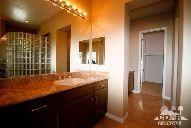 324 Loch Lomond Road Rancho Mirage, CA 92270 - Photo 33 of 51 a bathroom with a granite countertop sink and a mirror