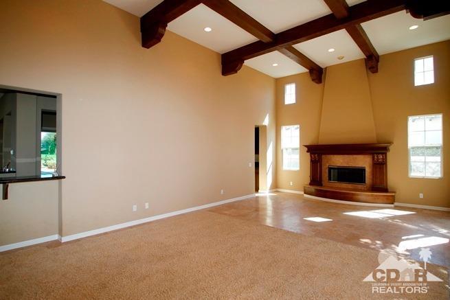 324 Loch Lomond Road Rancho Mirage, CA 92270 - Photo 6 of 51 a view of an empty room with a fireplace and a window
