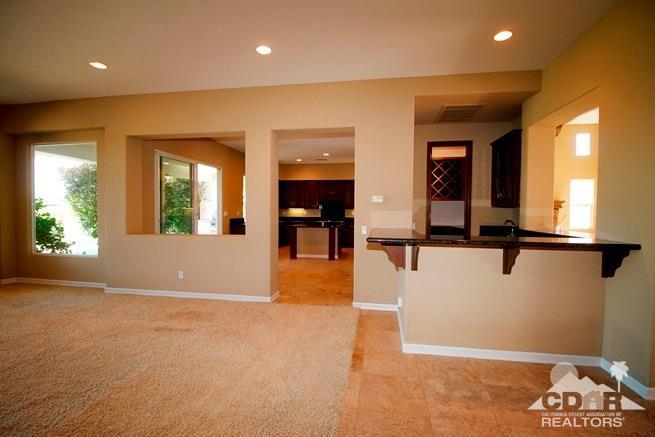 324 Loch Lomond Road Rancho Mirage, CA 92270 - Photo 8 of 51 an entryway in a hall with a window and a chandelier