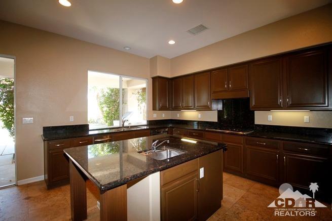 324 Loch Lomond Road Rancho Mirage, CA 92270 - Photo 9 of 51 a kitchen with a sink a stove a microwave and cabinets