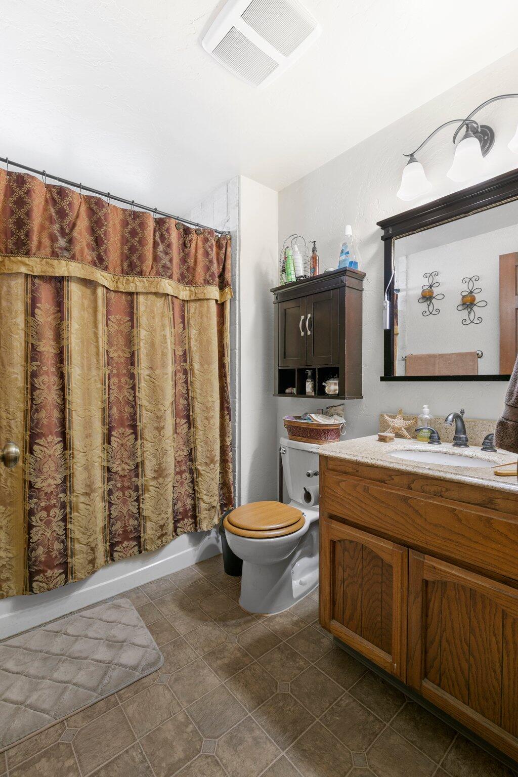 2592 Merriman Road Medford, OR 97501 - Photo 18 of 26 a bathroom with a toilet a sink and a shower