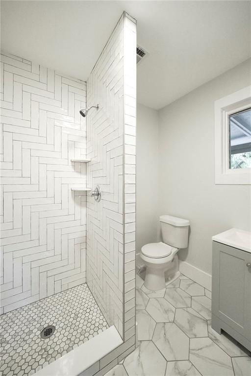 206 West 45th Street Austin, TX 78751 - Photo 5 of 6 a bathroom with a toilet a sink a shower and a window