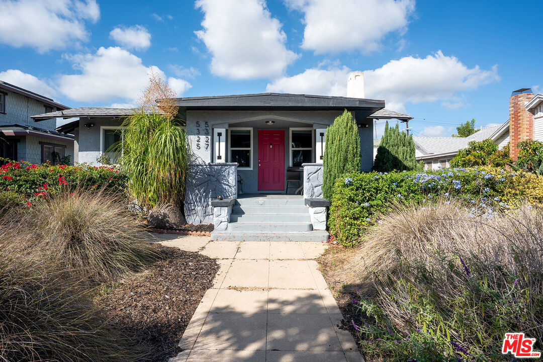a front view of a house with garden