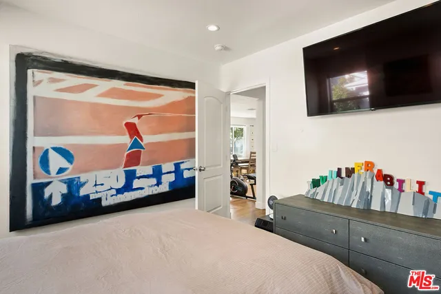 a bedroom with furniture and flat screen tv