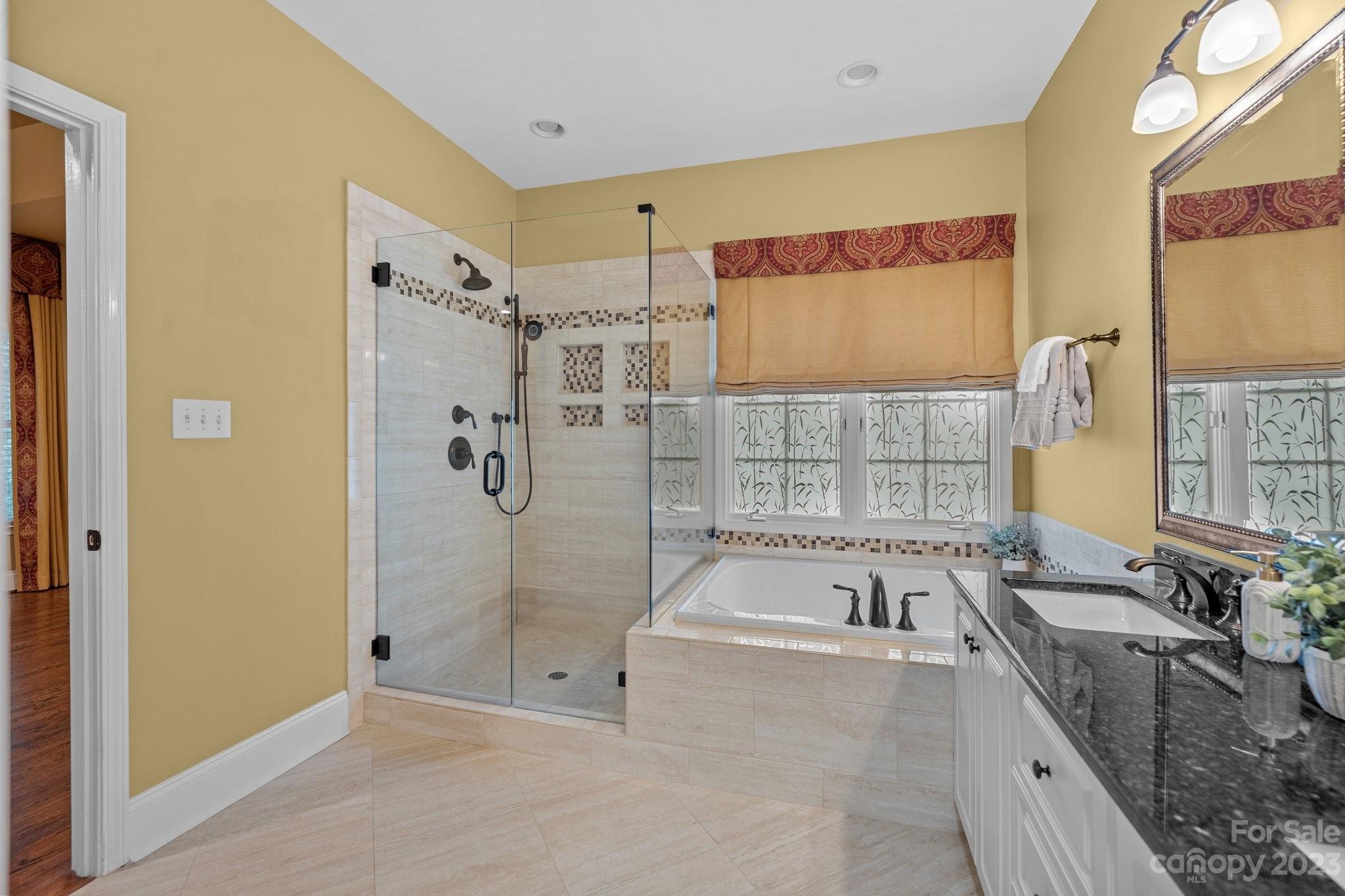 308 Gringley Hill Road Fort Mill, SC 29708 - Photo 11 of 23 a spacious bathroom with a granite countertop tub sink and mirror