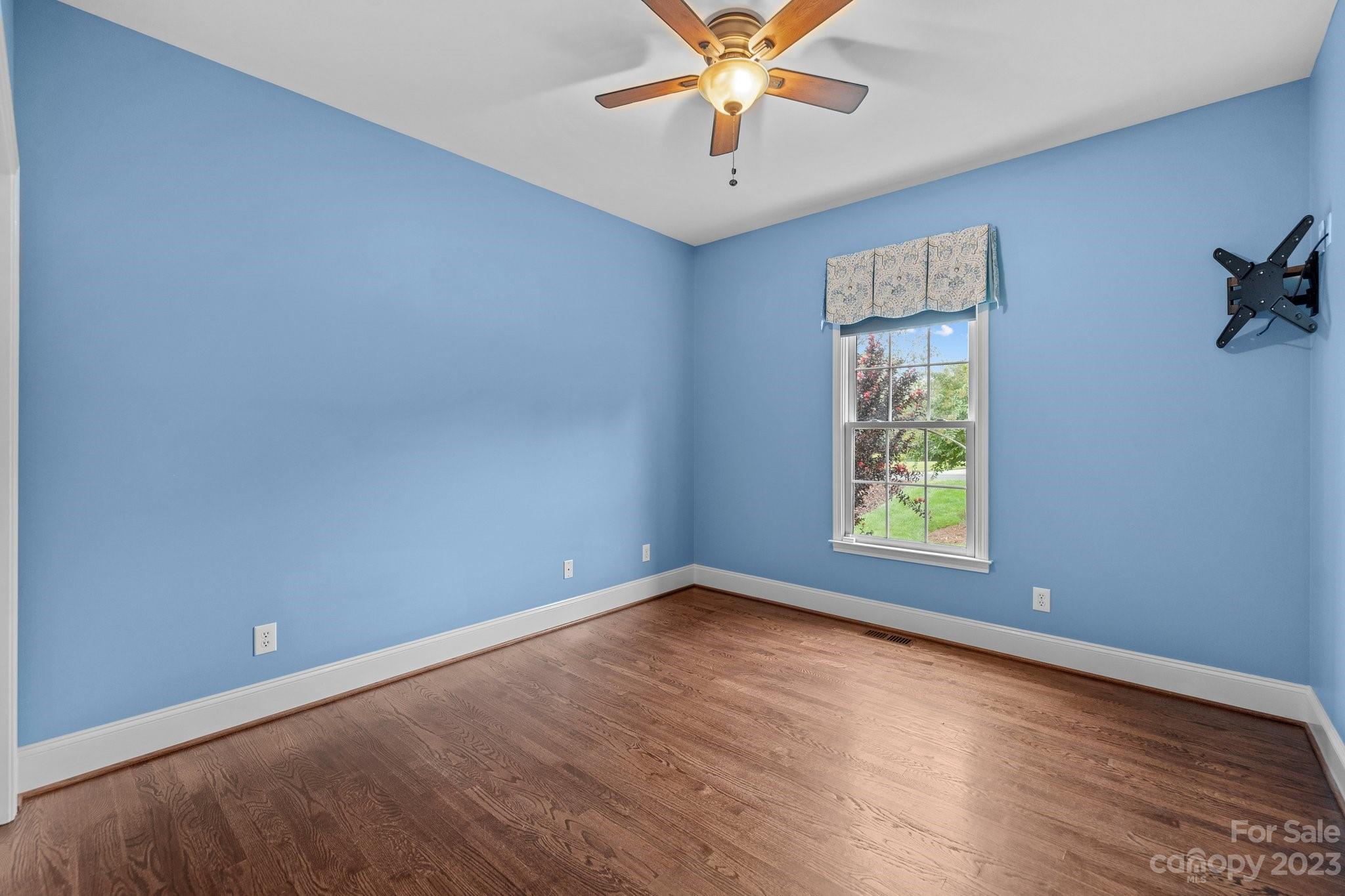 308 Gringley Hill Road Fort Mill, SC 29708 - Photo 18 of 23 an empty room with wooden floor and windows