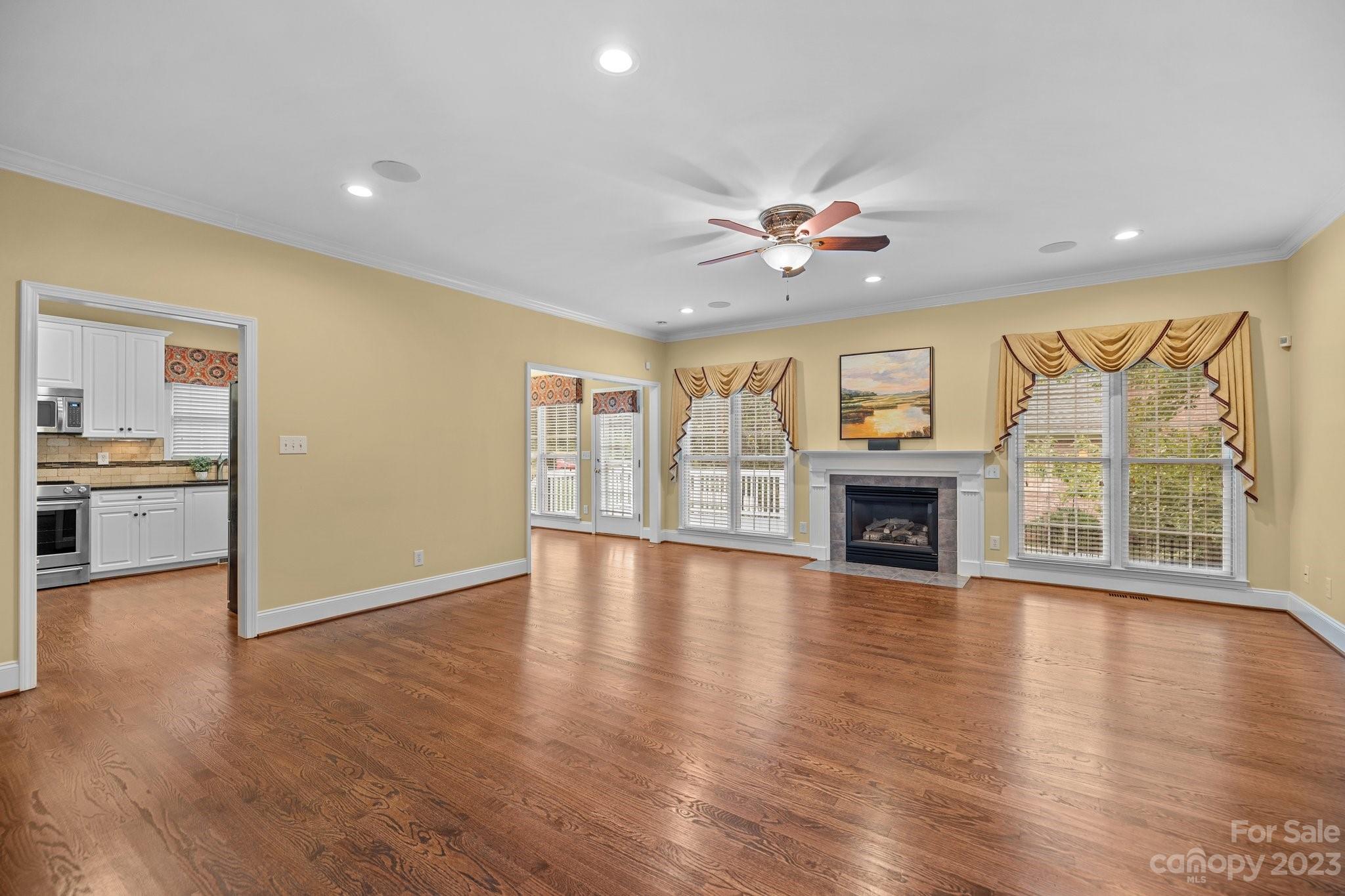 308 Gringley Hill Road Fort Mill, SC 29708 - Photo 4 of 23 a view of an empty room with wooden floor and a fireplace