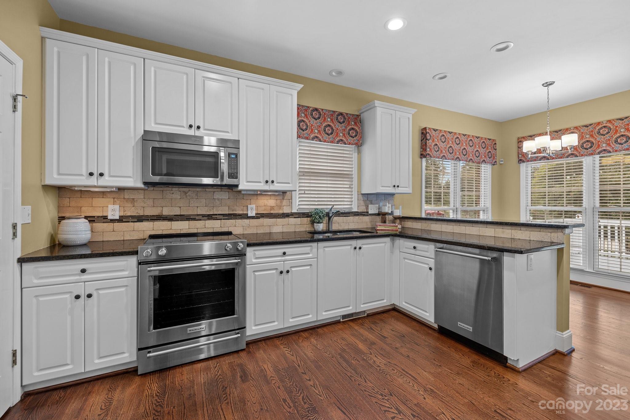 308 Gringley Hill Road Fort Mill, SC 29708 - Photo 7 of 23 a kitchen with stainless steel appliances granite countertop a stove a sink and a microwave