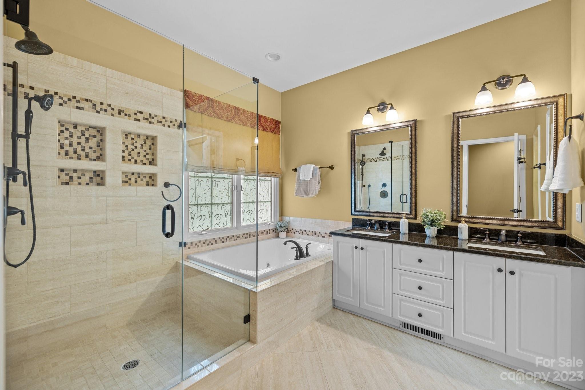 308 Gringley Hill Road Fort Mill, SC 29708 - Photo 10 of 23 a spacious bathroom with a granite countertop sink mirror and a bathtub