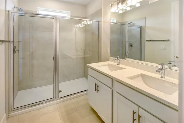 a bathroom with a shower sink and mirror