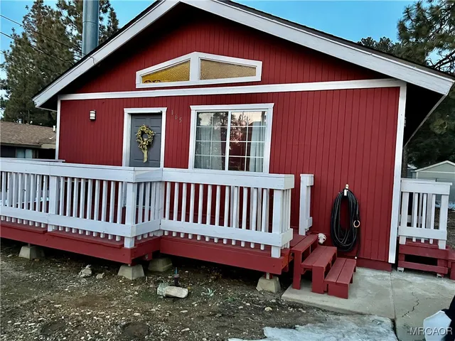 a front view of a house with a yard deck and furniture