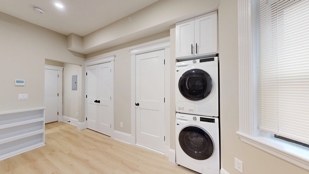 41 Edgerly Road, Unit 1 Boston, MA 02115 - Photo 4 of 12 a view of a hallway with washer and dryer
