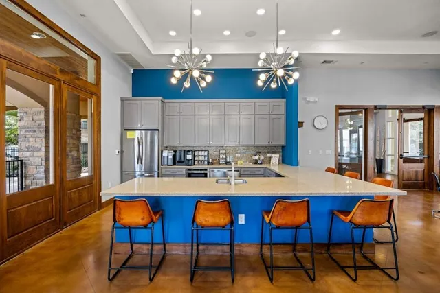 a large kitchen with a dining table and chairs