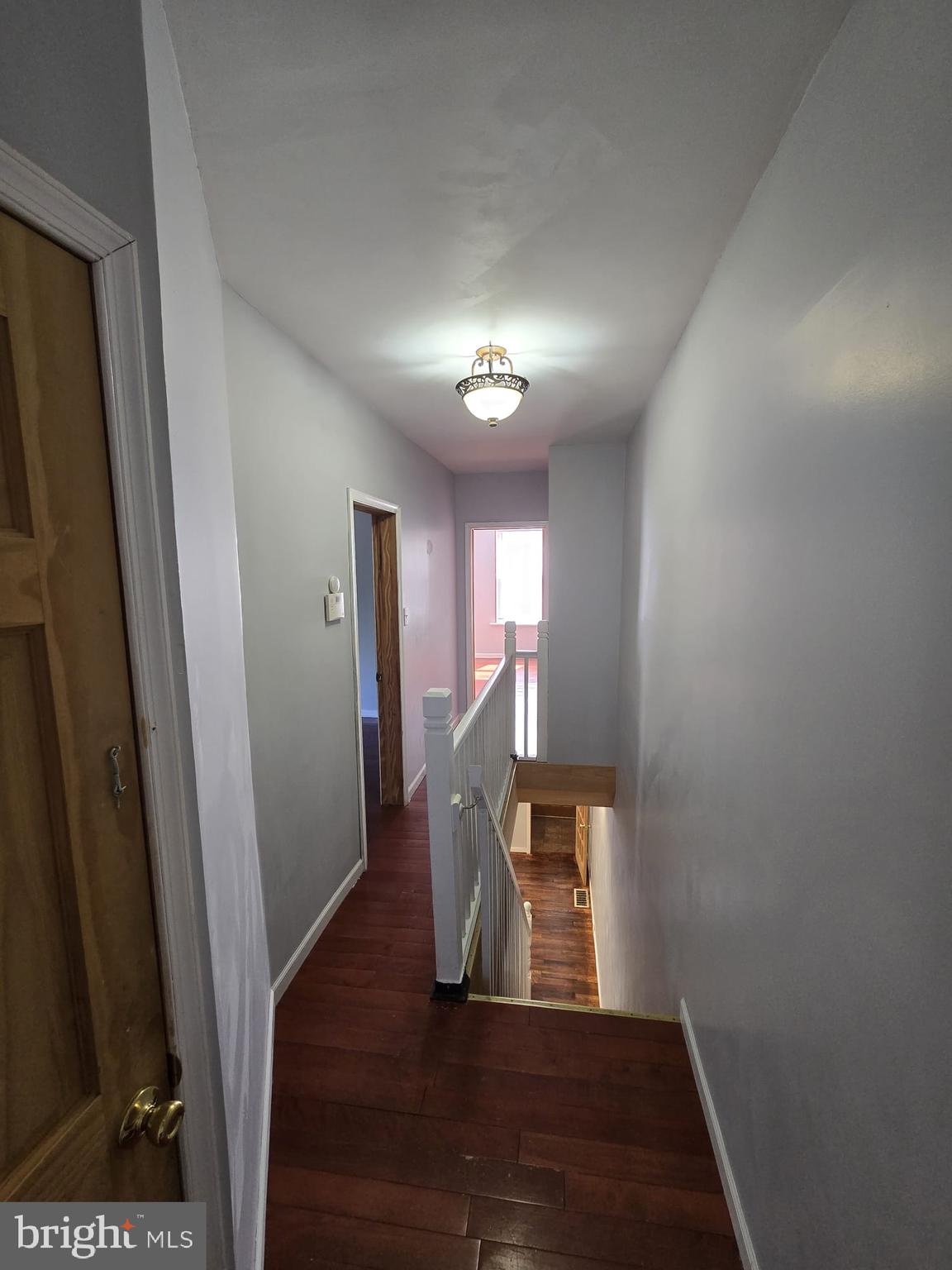 3410 North 16th Street Philadelphia, PA 19140 - Photo 12 of 20 a view of a hallway with wooden floor and stairs