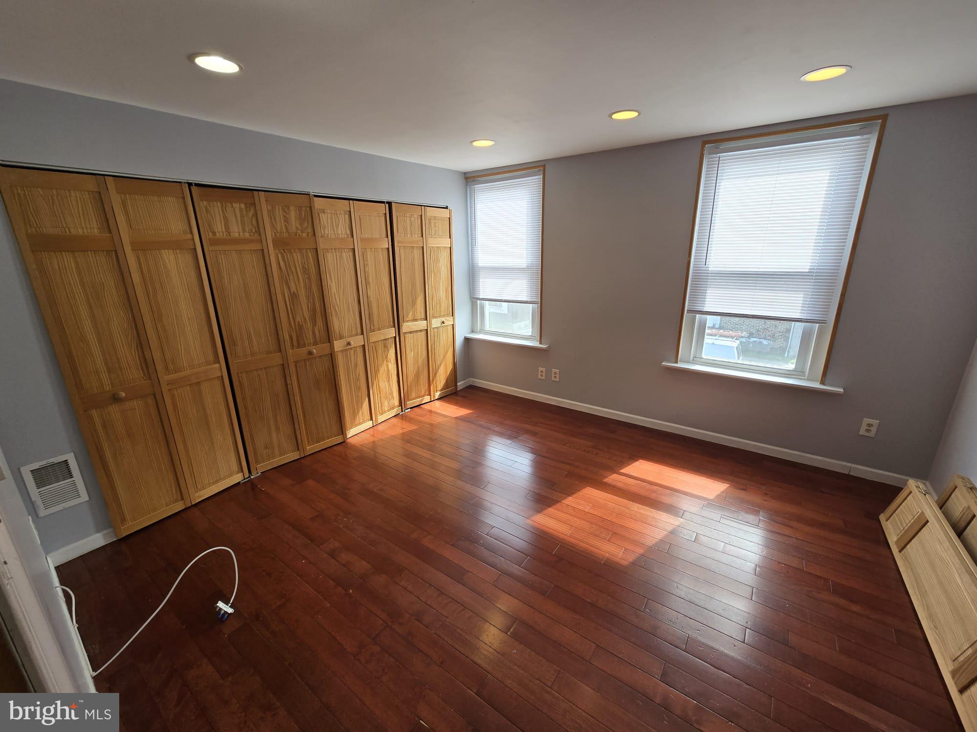 3410 North 16th Street Philadelphia, PA 19140 - Photo 14 of 20 an empty room with wooden floor and windows