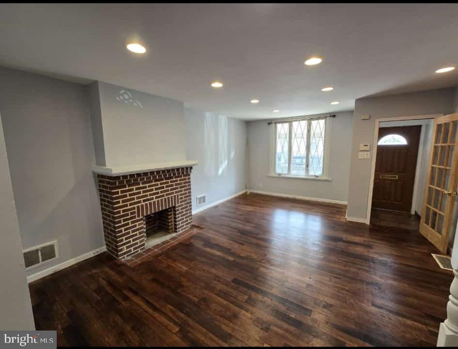 3410 North 16th Street Philadelphia, PA 19140 - Photo 3 of 20 a view of an empty room with wooden floor and a window