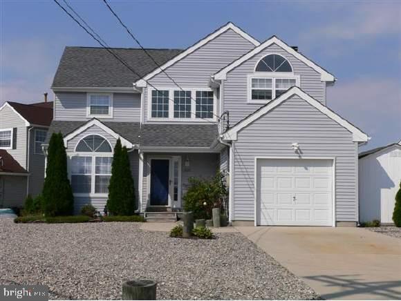 257 Allen Road Bayville, NJ 08721 - Photo 1 of 12 a front view of a house with a yard and garage