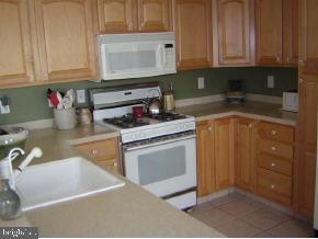 257 Allen Road Bayville, NJ 08721 - Photo 5 of 12 a kitchen with granite countertop a sink stove and cabinets