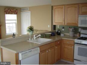 257 Allen Road Bayville, NJ 08721 - Photo 6 of 12 a kitchen with stainless steel appliances granite countertop a sink a stove and white cabinets