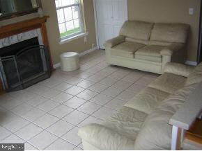 257 Allen Road Bayville, NJ 08721 - Photo 8 of 12 a living room with furniture a flat screen tv and a fireplace