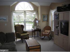 257 Allen Road Bayville, NJ 08721 - Photo 9 of 12 a living room with furniture a fireplace and a large window