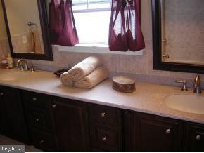 257 Allen Road Bayville, NJ 08721 - Photo 10 of 12 a bathroom with a sink and a mirror