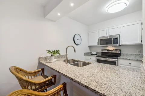 a view of a sink a counter top space in the room