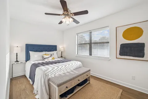 a bedroom with a bed and a chandelier