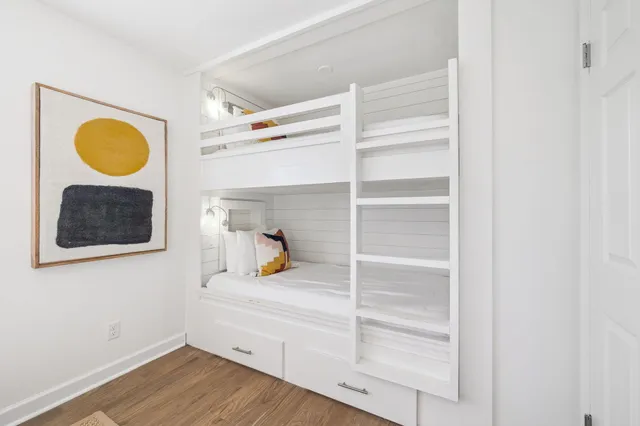 a bathroom with a granite countertop sink a mirror and a bathtub