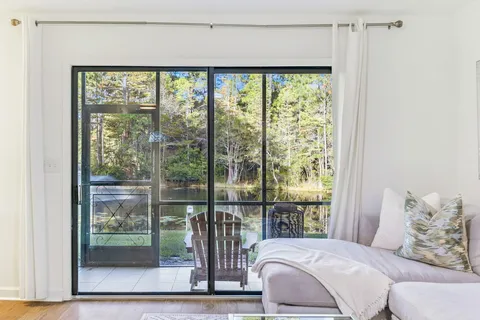 a view of a chair and tables in the balcony